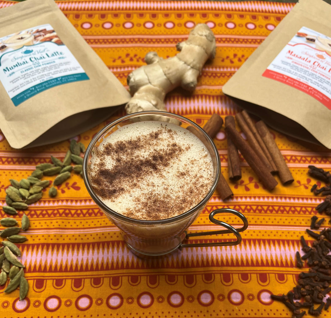 Mumbai Chai and Masaala Chai Latte Packets Displayed with Herbs and Brewed Latte 