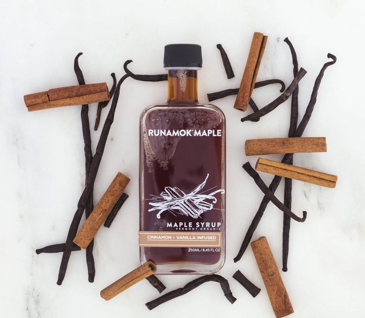 cinnamon vanilla maple syrup jar with vanilla beans and cinnamon sticks 