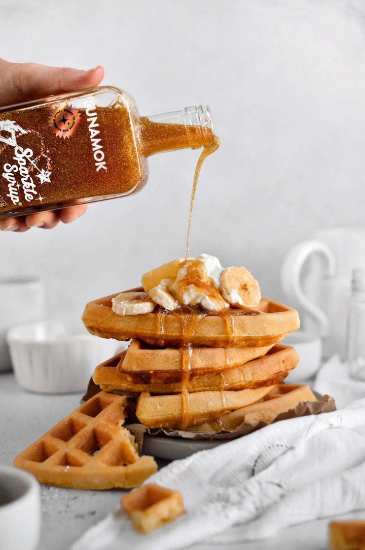 runamok maple syrup with sparkles pouring on waffles 