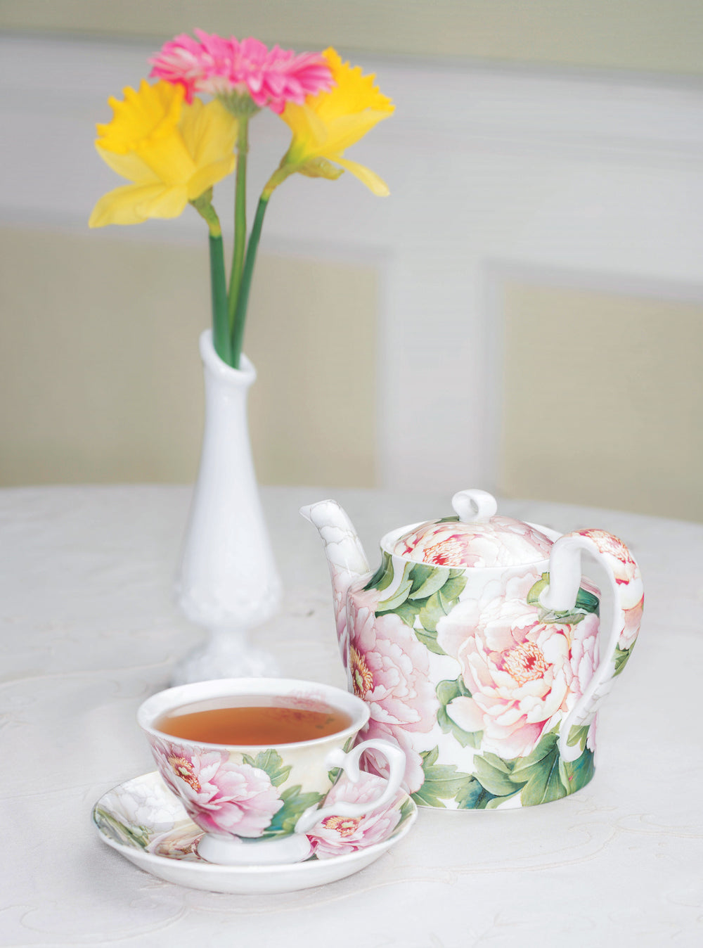 Peony Teacup and Saucer with Brewed Tea and Peony Teapot